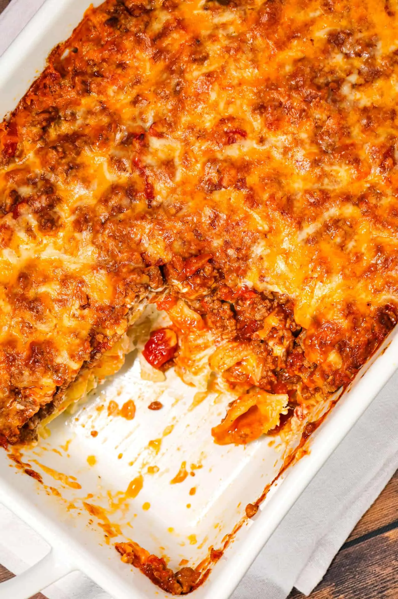 Taco Pasta Casserole is an easy ground beef pasta recipe made with shell loaded with sour cream, cream cheese, ranch dressing mix, taco seasoning, Rotel, tomato sauce and baked with shredded cheese.