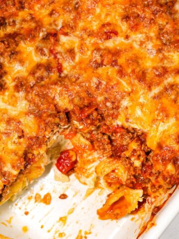 Taco Pasta Casserole is an easy ground beef pasta recipe made with shell loaded with sour cream, cream cheese, ranch dressing mix, taco seasoning, Rotel, tomato sauce and baked with shredded cheese.