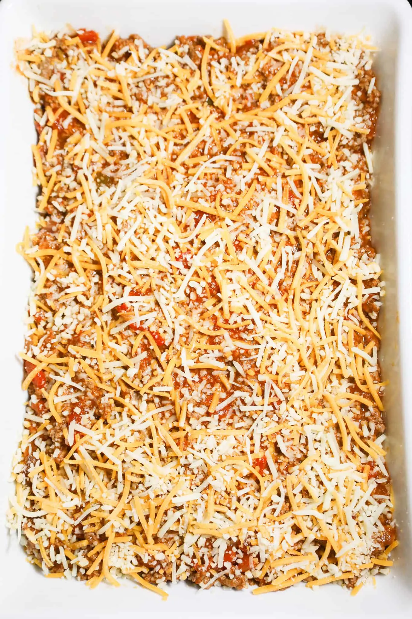 shredded cheese on top of taco pasta before baking