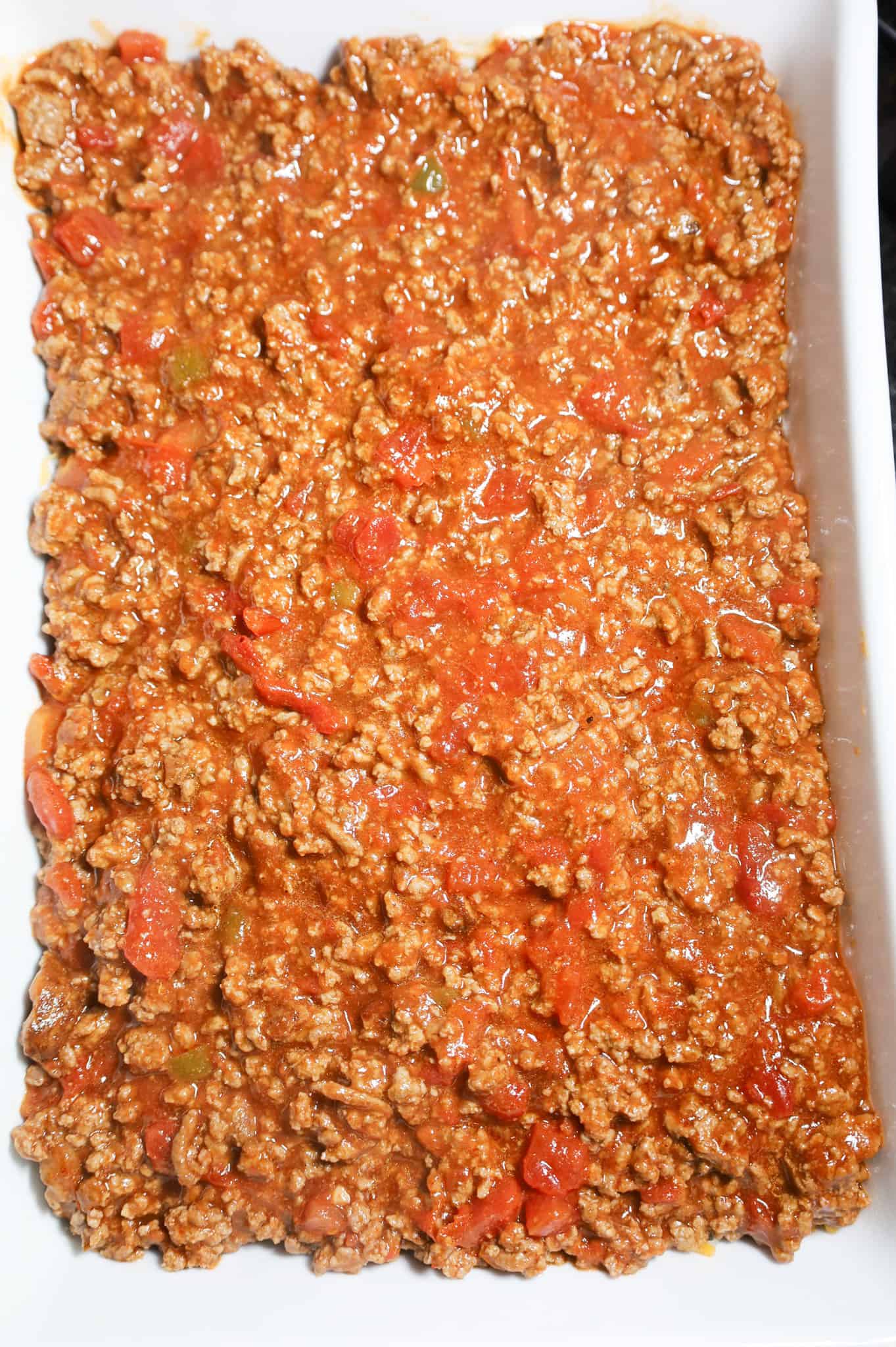 ground beef and tomato sauce mixture in a casserole dish