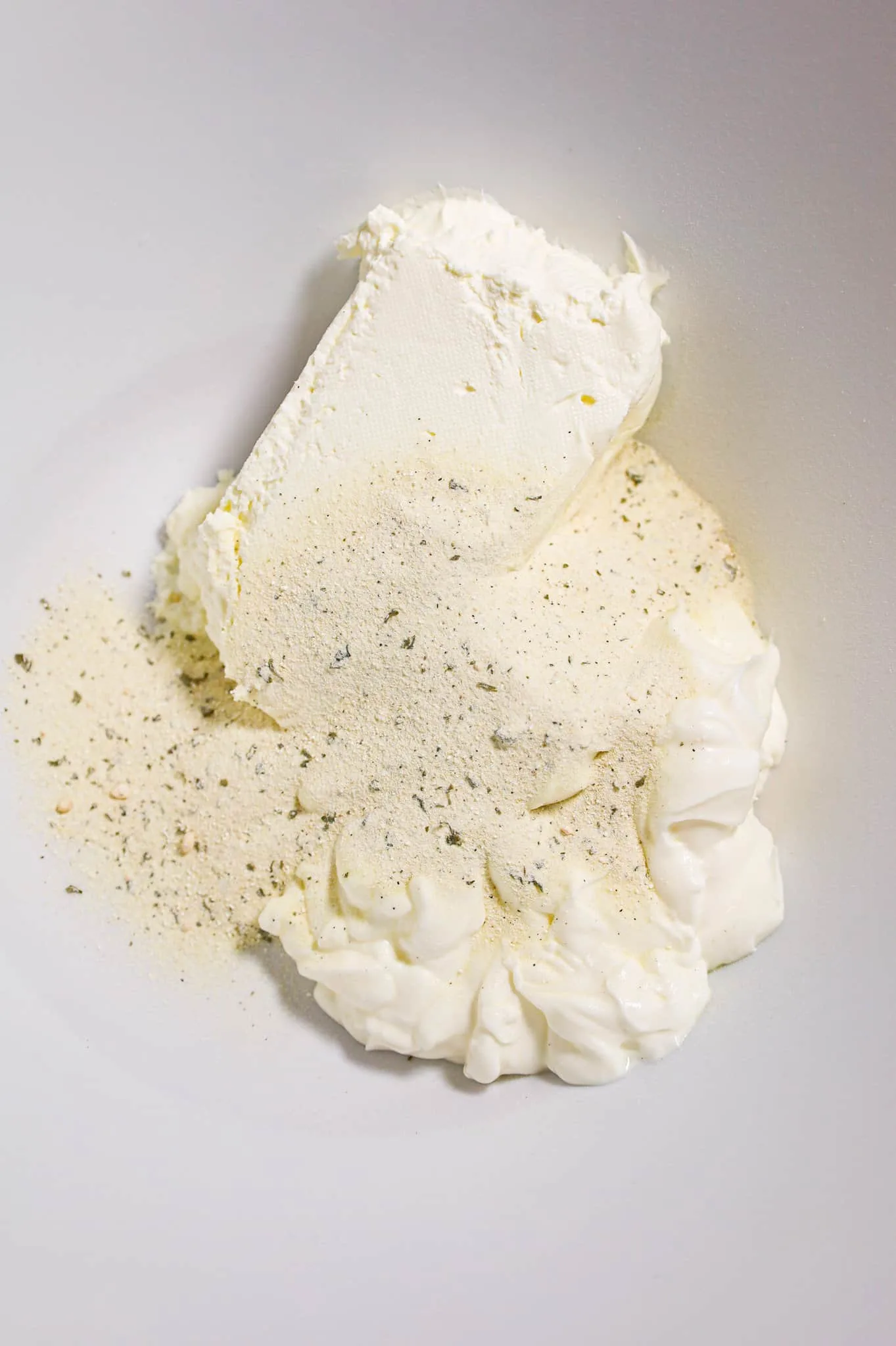 softened cream cheese, sour cream and ranch dressing mix in a mixing bowl