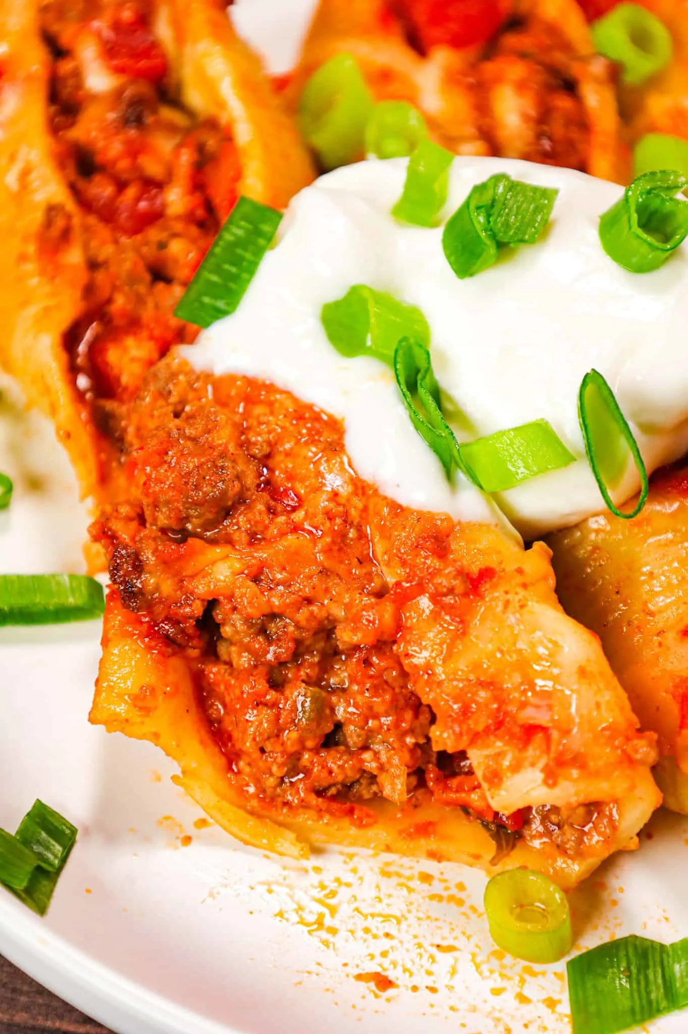 Taco Stuffed Shells are cheesy ground beef stuffed pasta shells loaded with salsa and Rotel diced tomatoes and green chilies.