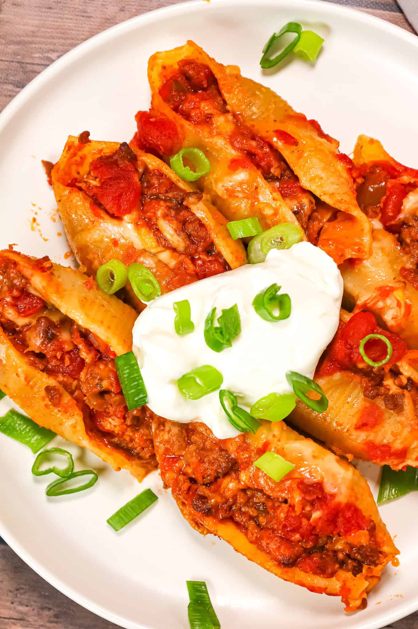 Taco Stuffed Shells are cheesy ground beef stuffed pasta shells loaded with salsa and Rotel diced tomatoes and green chilies.