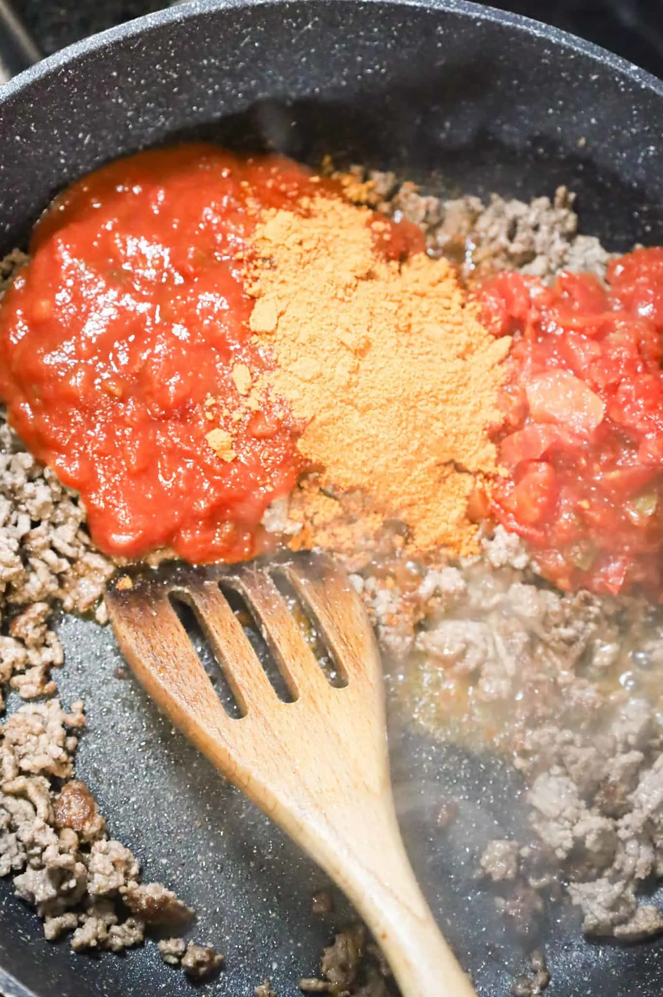 salsa, Rotel and taco seasoning on top of cooked ground beef in a skillet