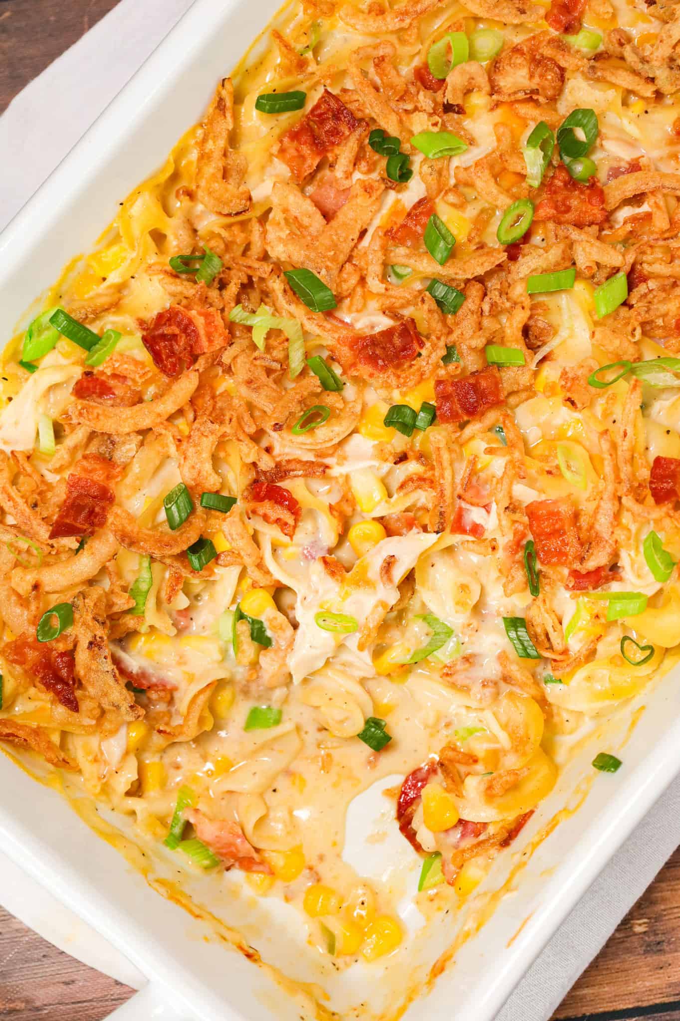Ultimate Chicken Casserole is a hearty casserole loaded with egg noodles, shredded chicken, chopped bacon, green onions and shredded cheese all tossed in a creamy soup mixture and baked with French's crispy fried onions on top.