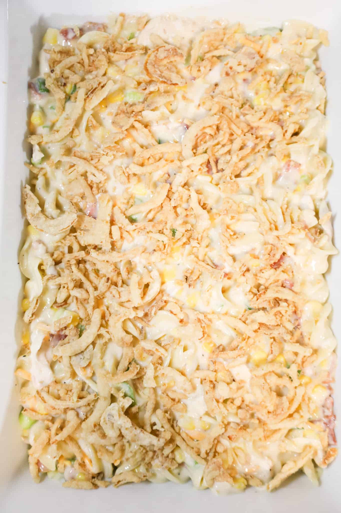 French's crispy fried onions on top of creamy chicken noodle mixture in a casserole dish
