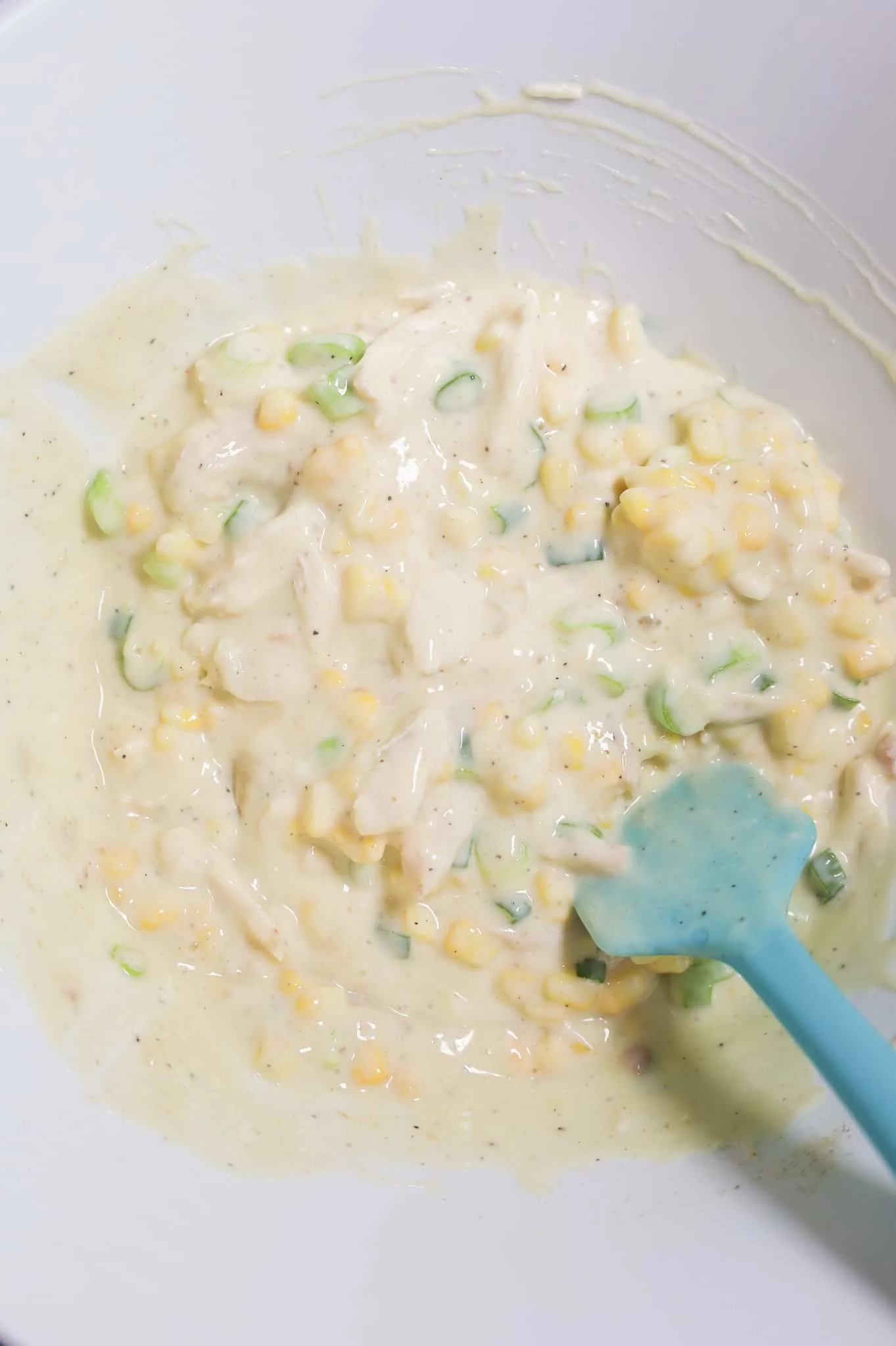 creamy soup and chicken mixture in a mixing bowl