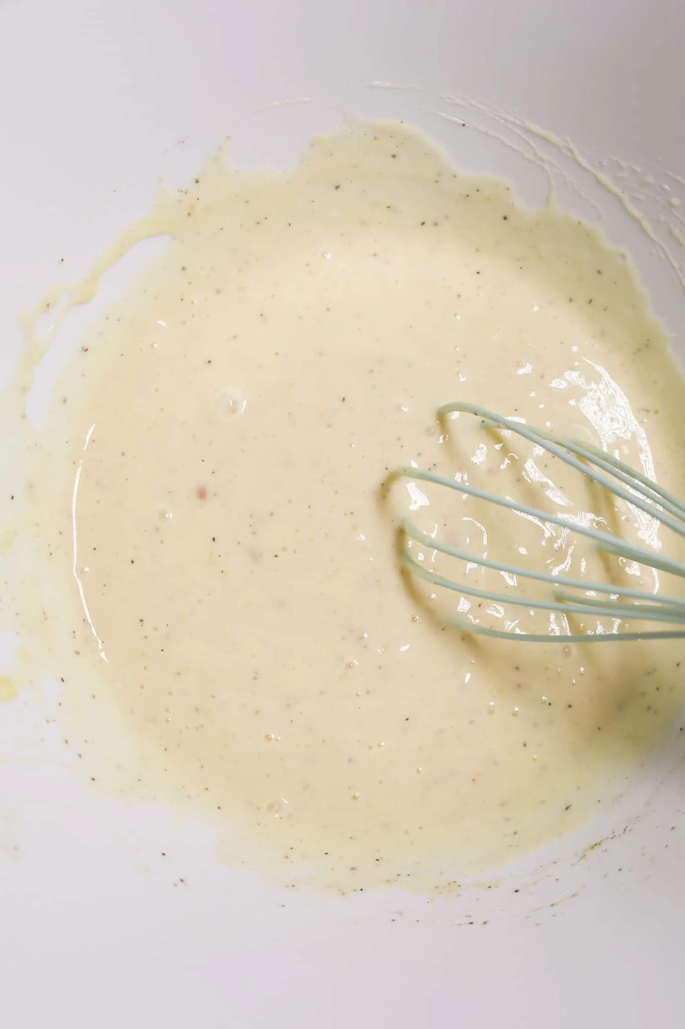 creamy soup and seasoning mixture in a mixing bowl