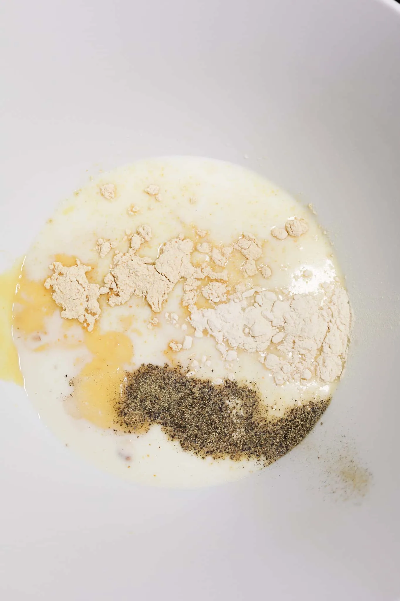 milk, salt, pepper, garlic powder and onion powder in a mixing bowl