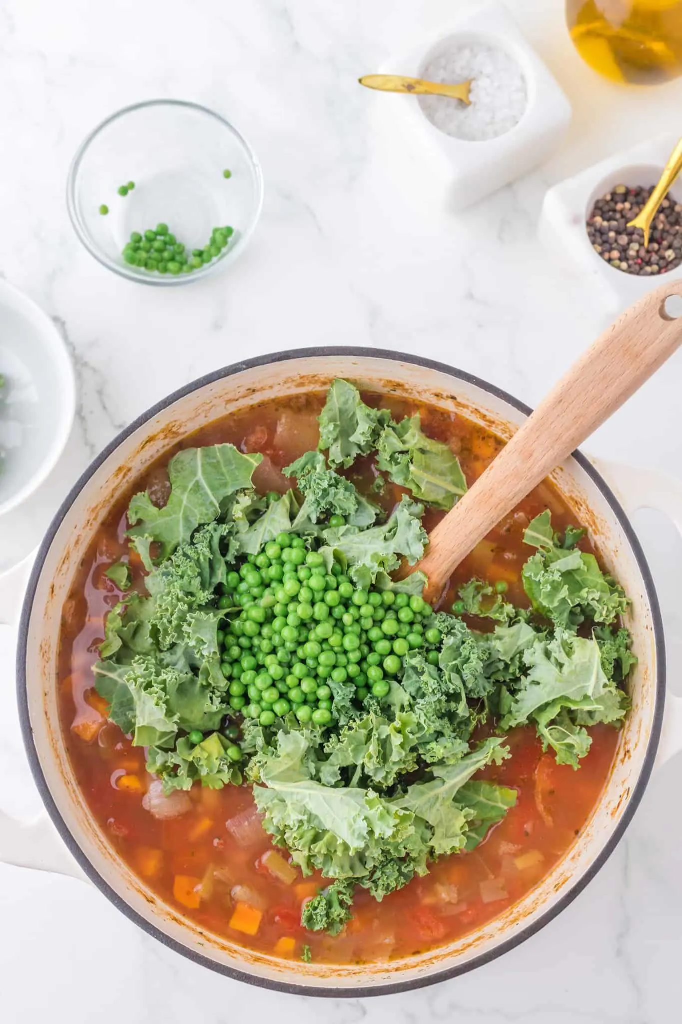 frozen peas and chopped kale added to vegetable barley soup