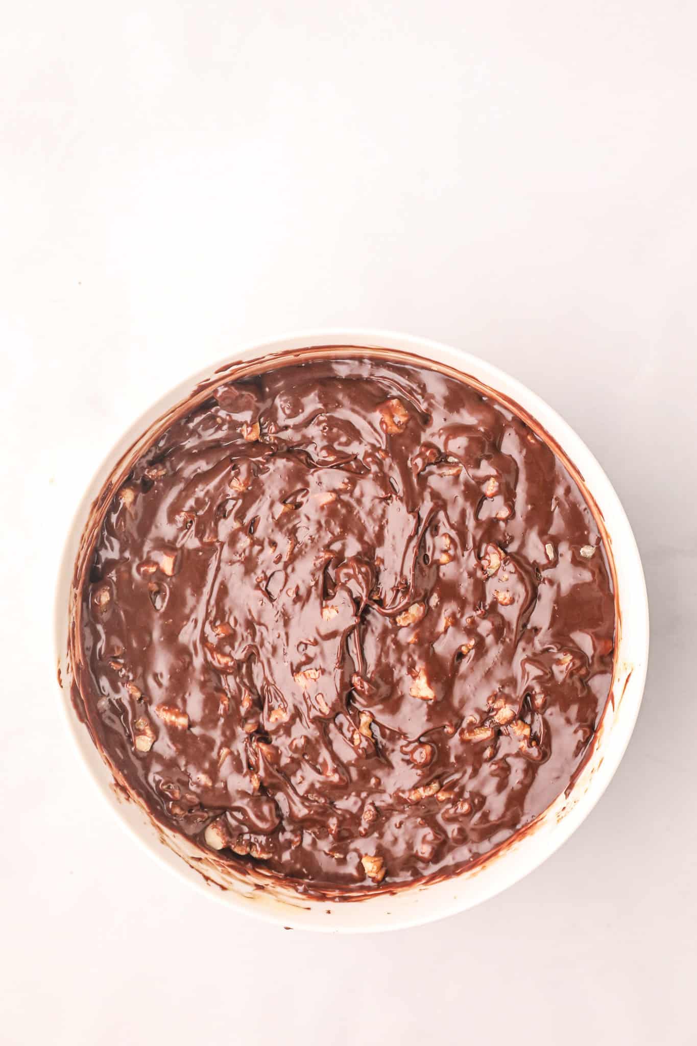 melted chocolate fudge and walnut mixture in a mixing bowl