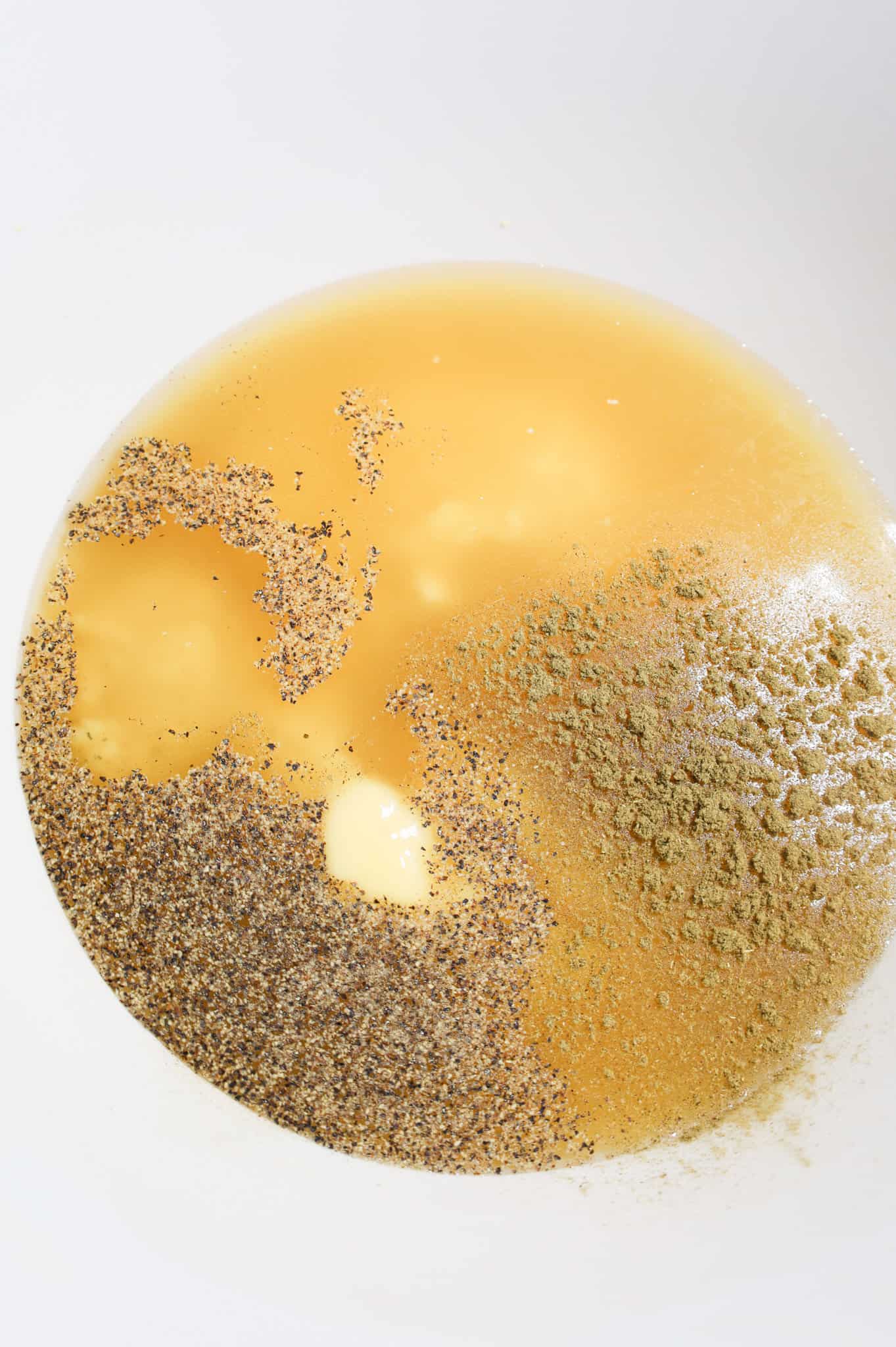 salt, pepper, sage and chicken broth in a mixing bowl