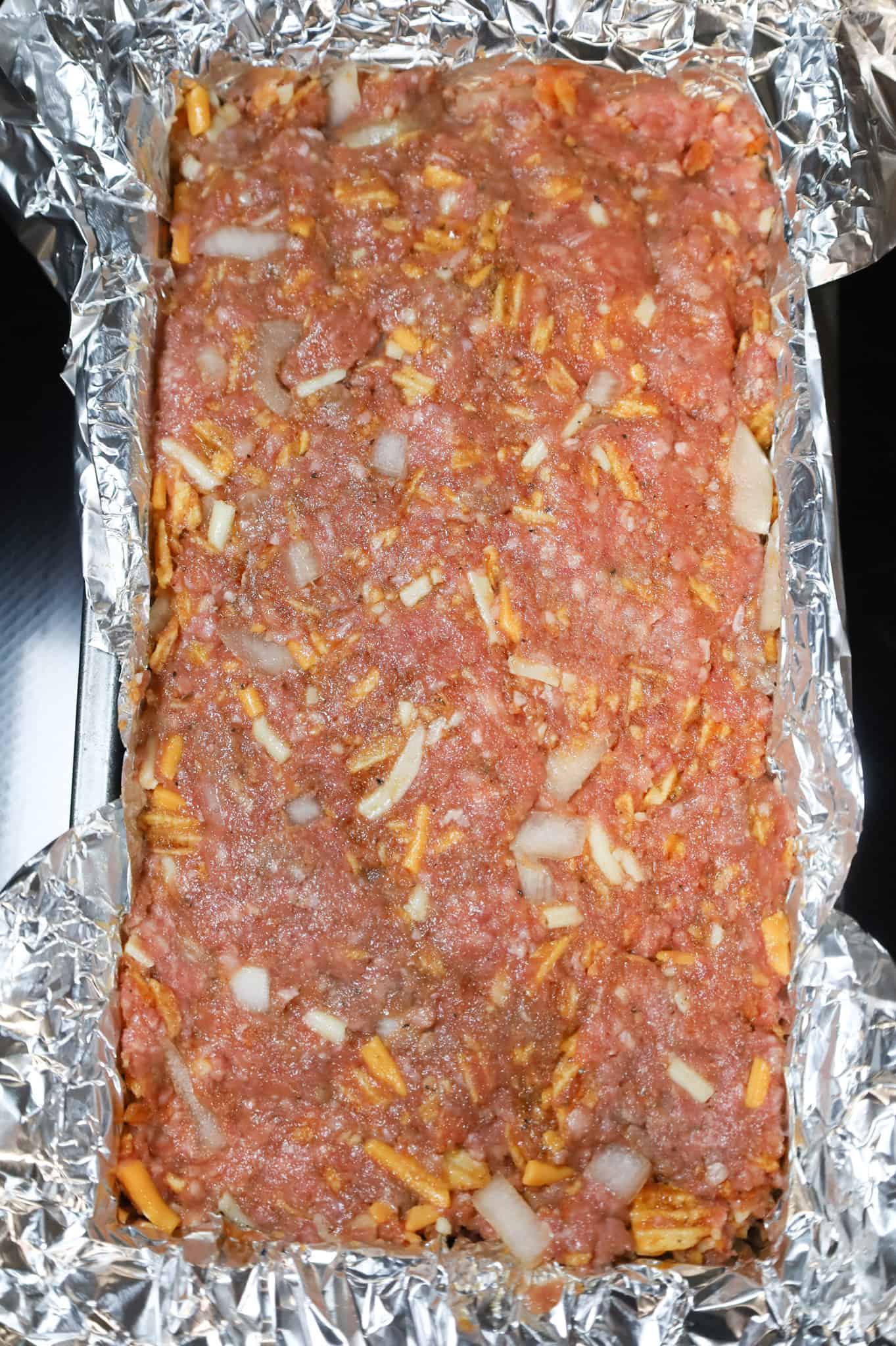 meatloaf mixture in a foil lined pan before baking