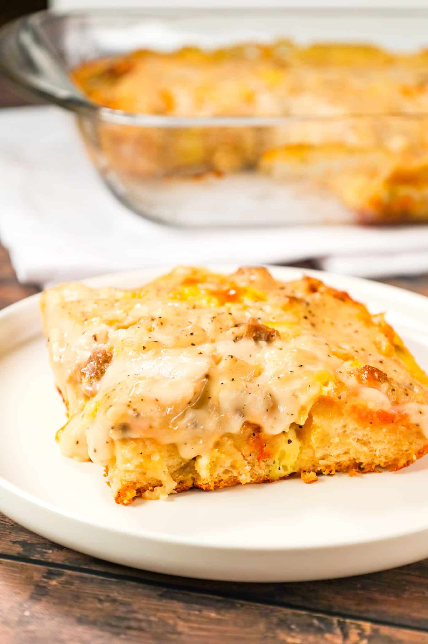 Biscuit and Gravy Casserole is a hearty breakfast dish made with Pillsbury biscuits and loaded with crumbled sausage, cheddar cheese and peppered gravy.