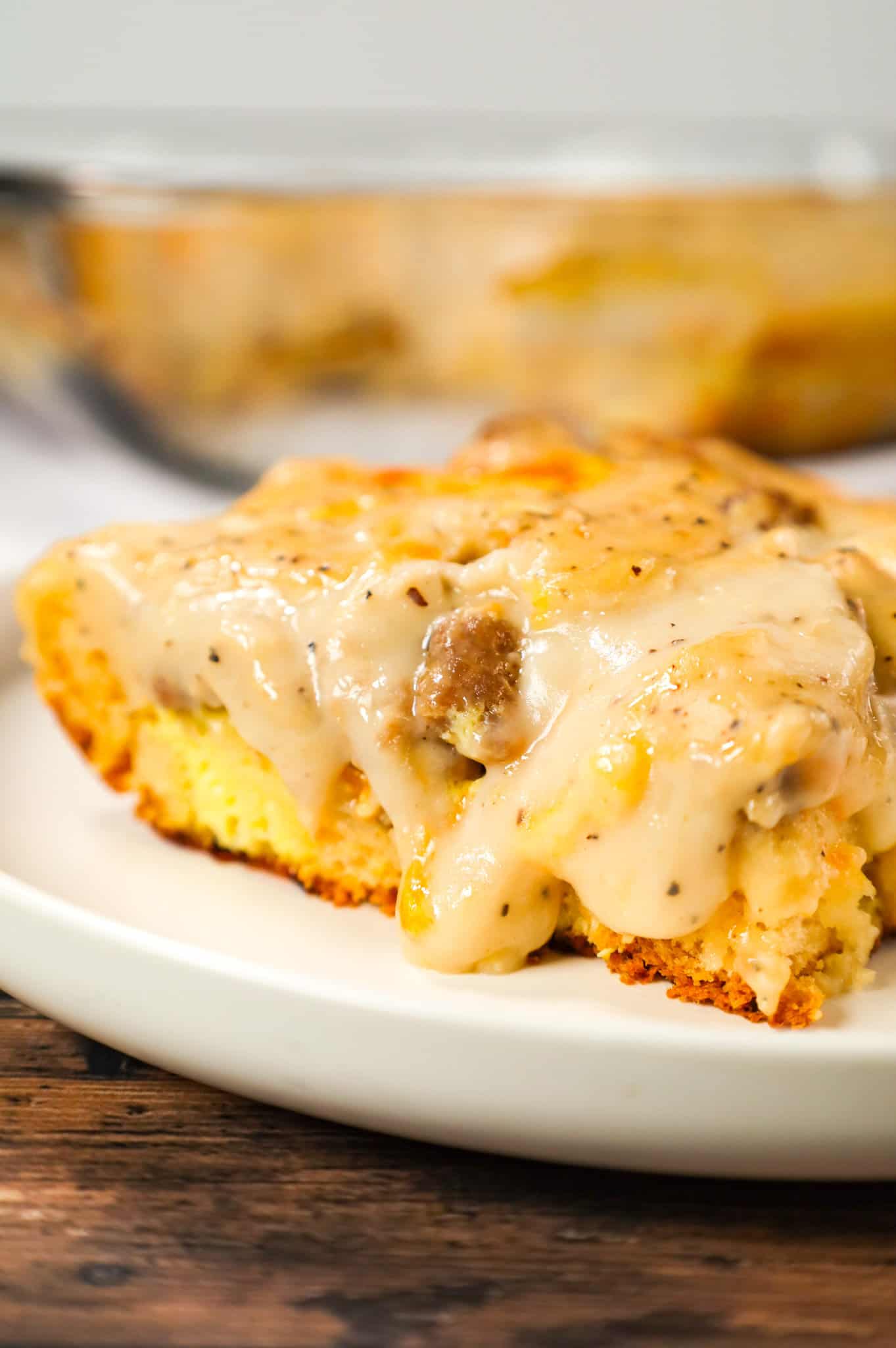Biscuit and Gravy Casserole is a hearty breakfast dish made with Pillsbury biscuits and loaded with crumbled sausage, cheddar cheese and peppered gravy.