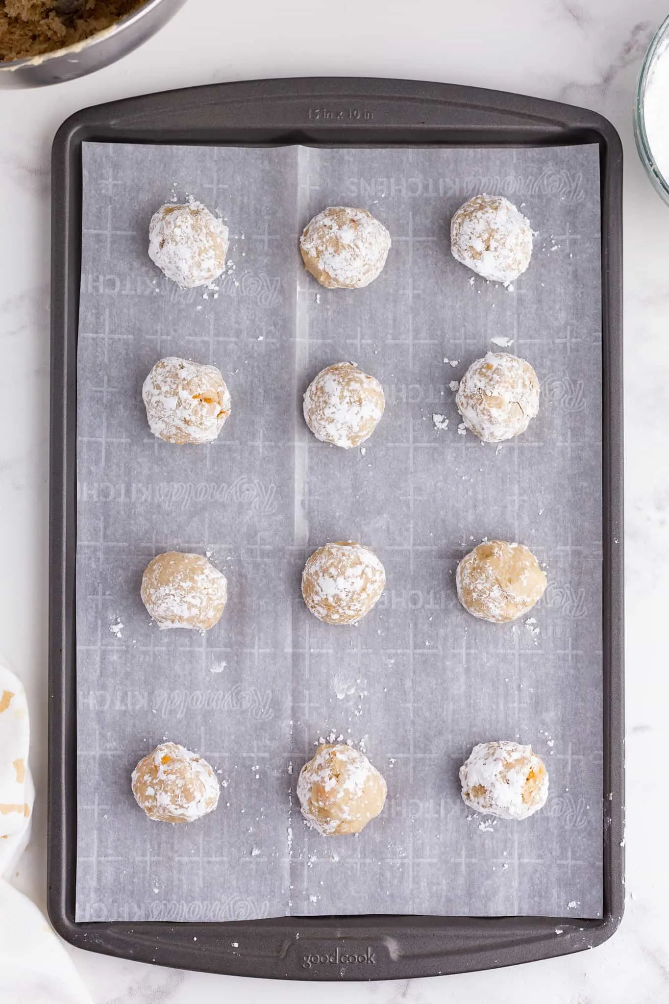 butterscotch cookie dough balls on a parchment paper lined baking sheet