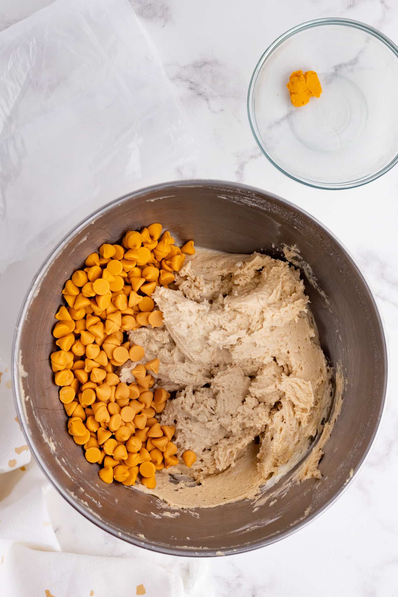 butterscotch chips added to bowl with cookie dough