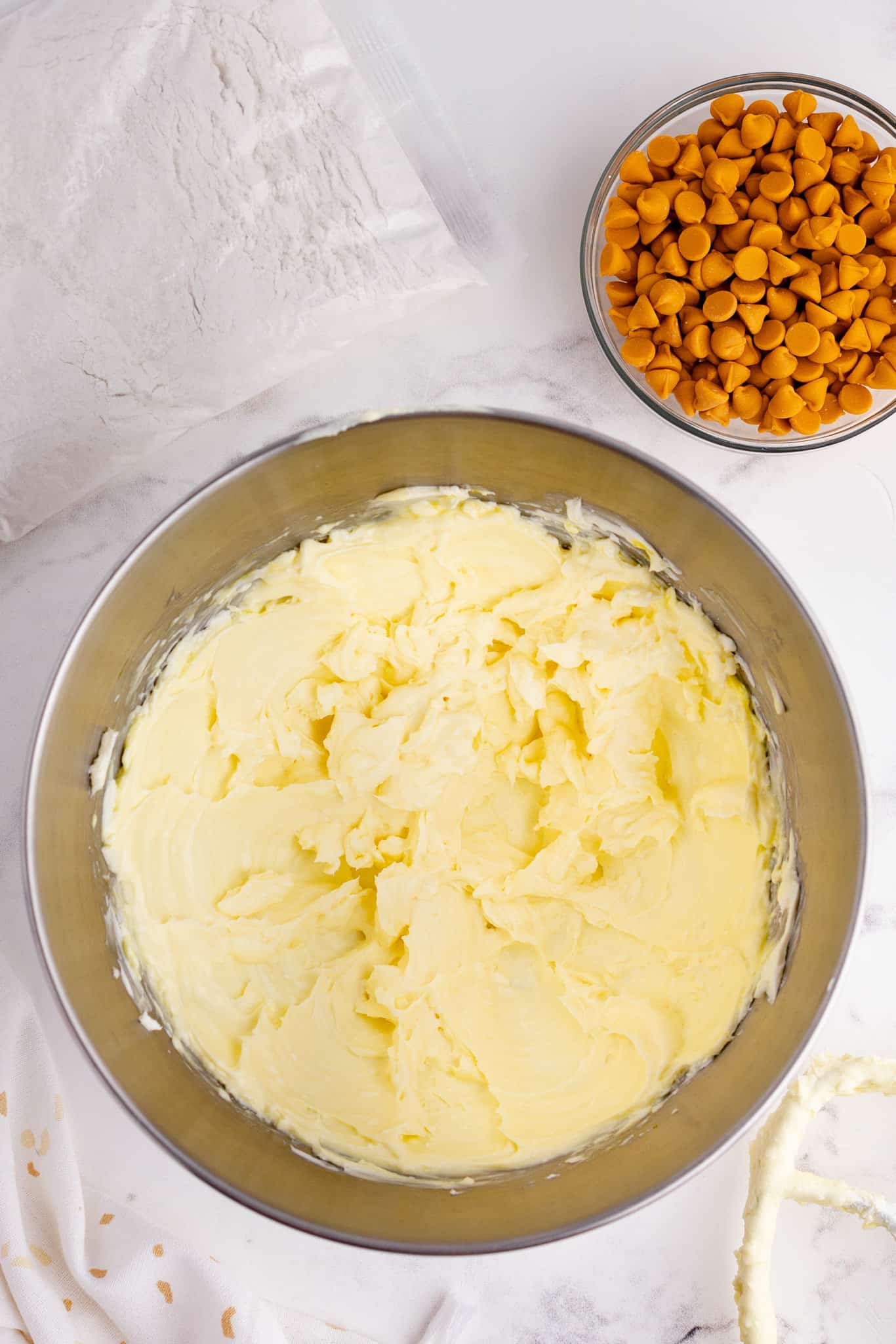 cream butter and cream cheese mixture in a mixin gbowl