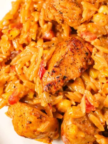 Cajun Chicken Orzo is a delicious one pot dinner recipe loaded with chicken breast chunks, corn, Rotel diced tomatoes and orzo pasta all in a creamy Cajun sauce.