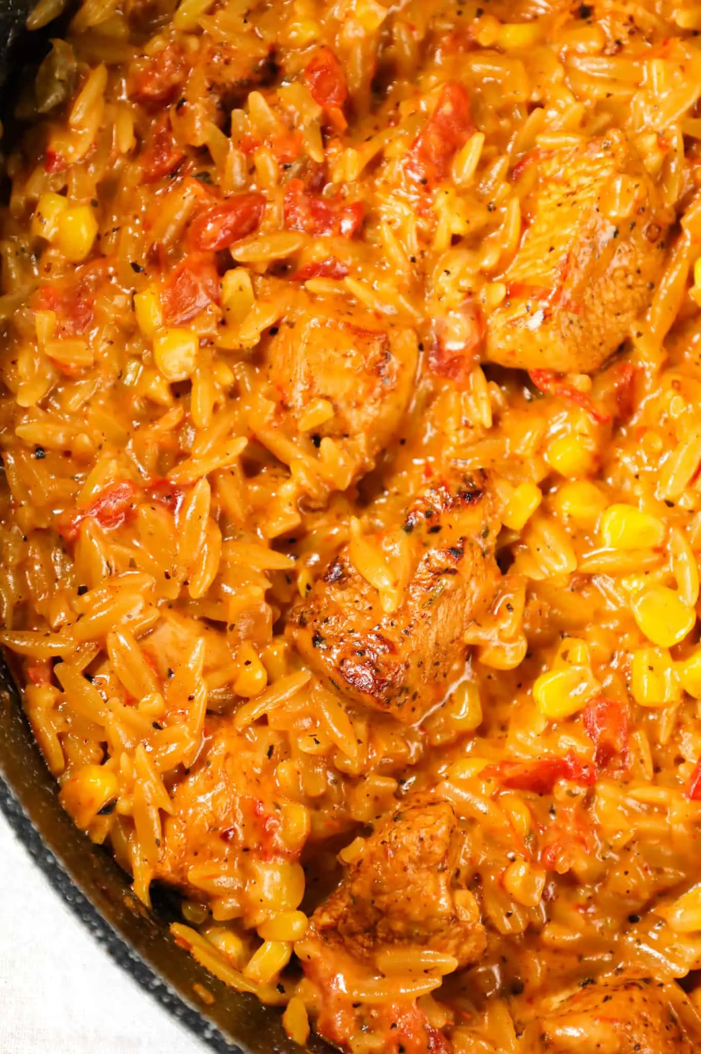 Cajun Chicken Orzo is a delicious one pot dinner recipe loaded with chicken breast chunks, corn, Rotel diced tomatoes and orzo pasta all in a creamy Cajun sauce.