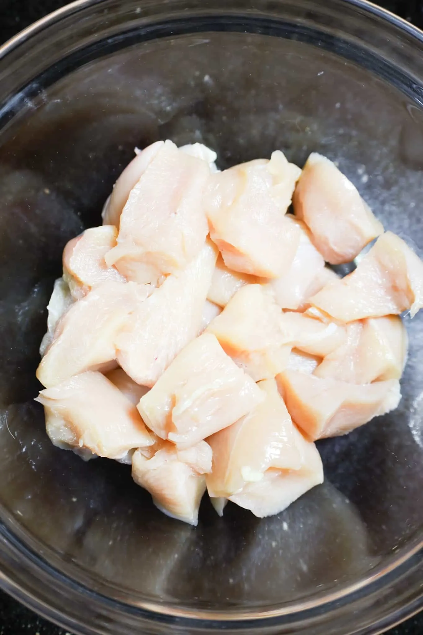 raw chicken breast chunks in a bowl