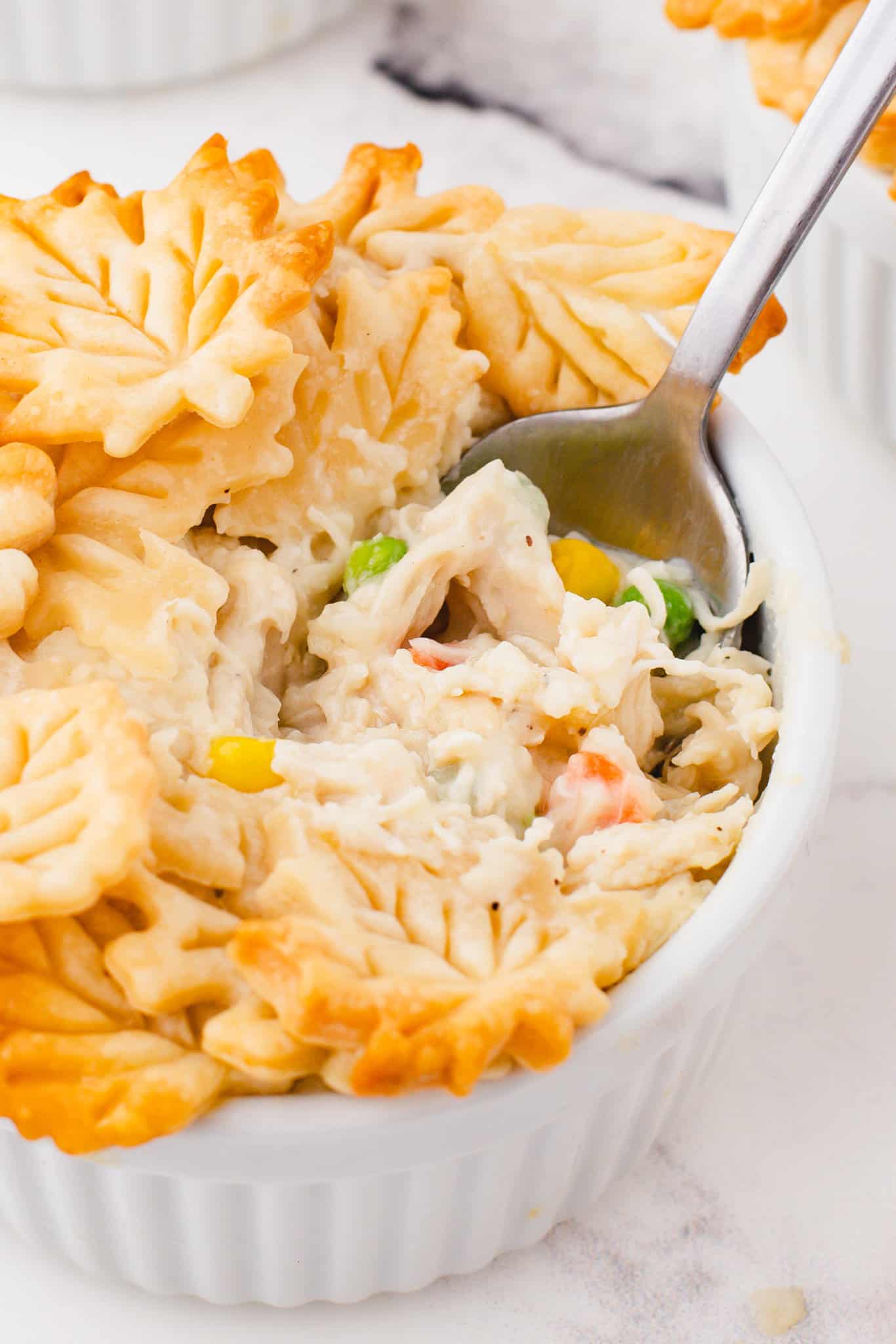 Easy Chicken Pot Pie is a hearty comfort food dish with a creamy chicken and vegetable filling topped with golden brown Pillsbury pie crust.