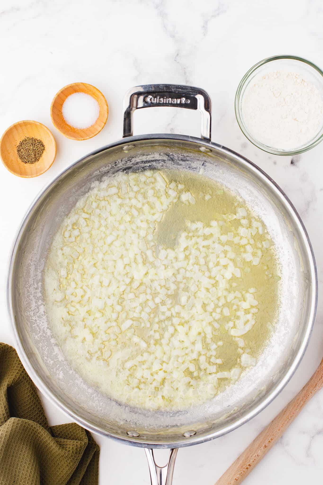 melted butter and diced onions cooking in a skillet