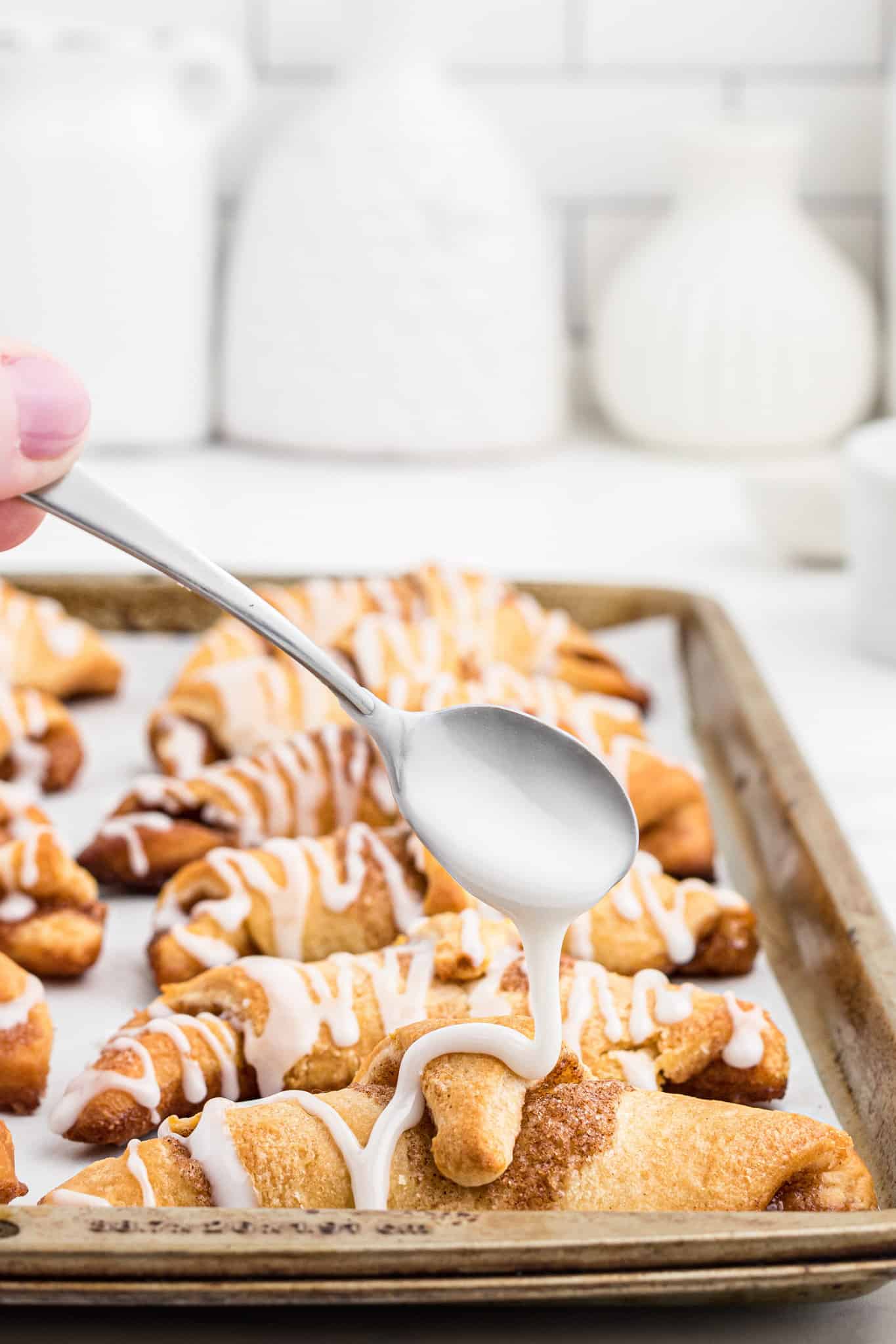 Cinnamon Crescent Rolls are an easy breakfast or dessert recipe using Pillsbury crescent rolls filled with a sweet cinnamon mixture and drizzled with icing.