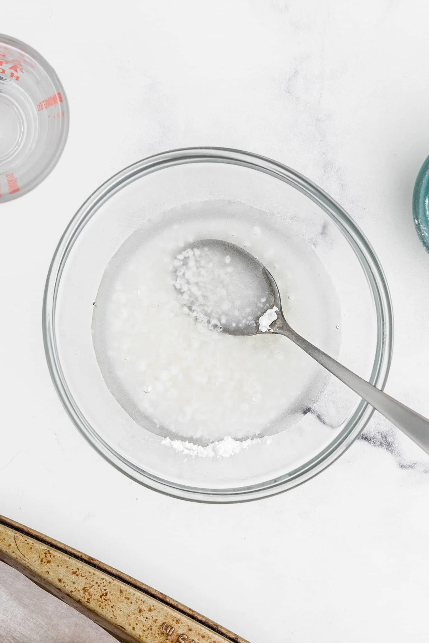 powdered sugar and water in a mixing bowl
