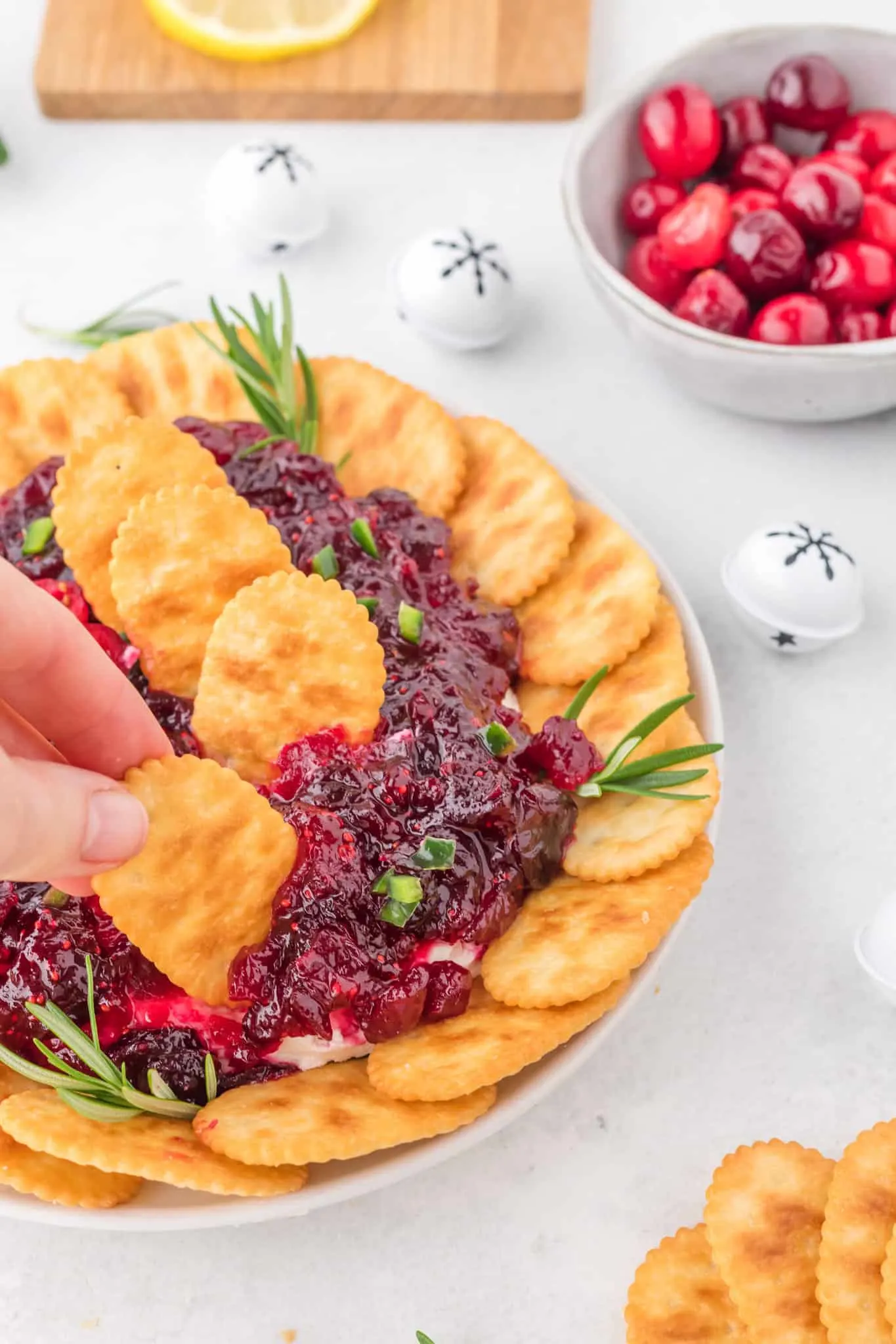 Cranberry Cream Cheese Dip is a delicious party dip recipe with a cream cheese jalapeno base topped with cranberry sauce.