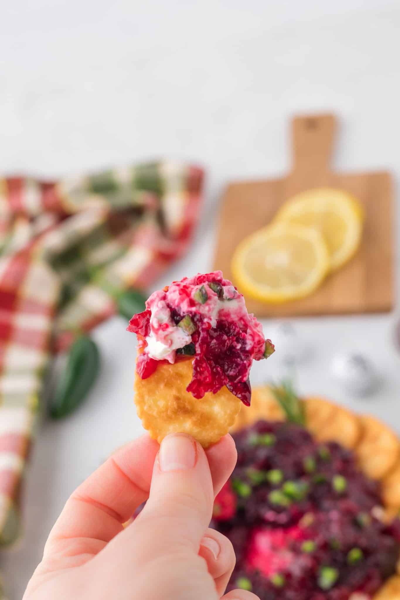 Cranberry Cream Cheese Dip is a delicious party dip recipe with a cream cheese jalapeno base topped with cranberry sauce.