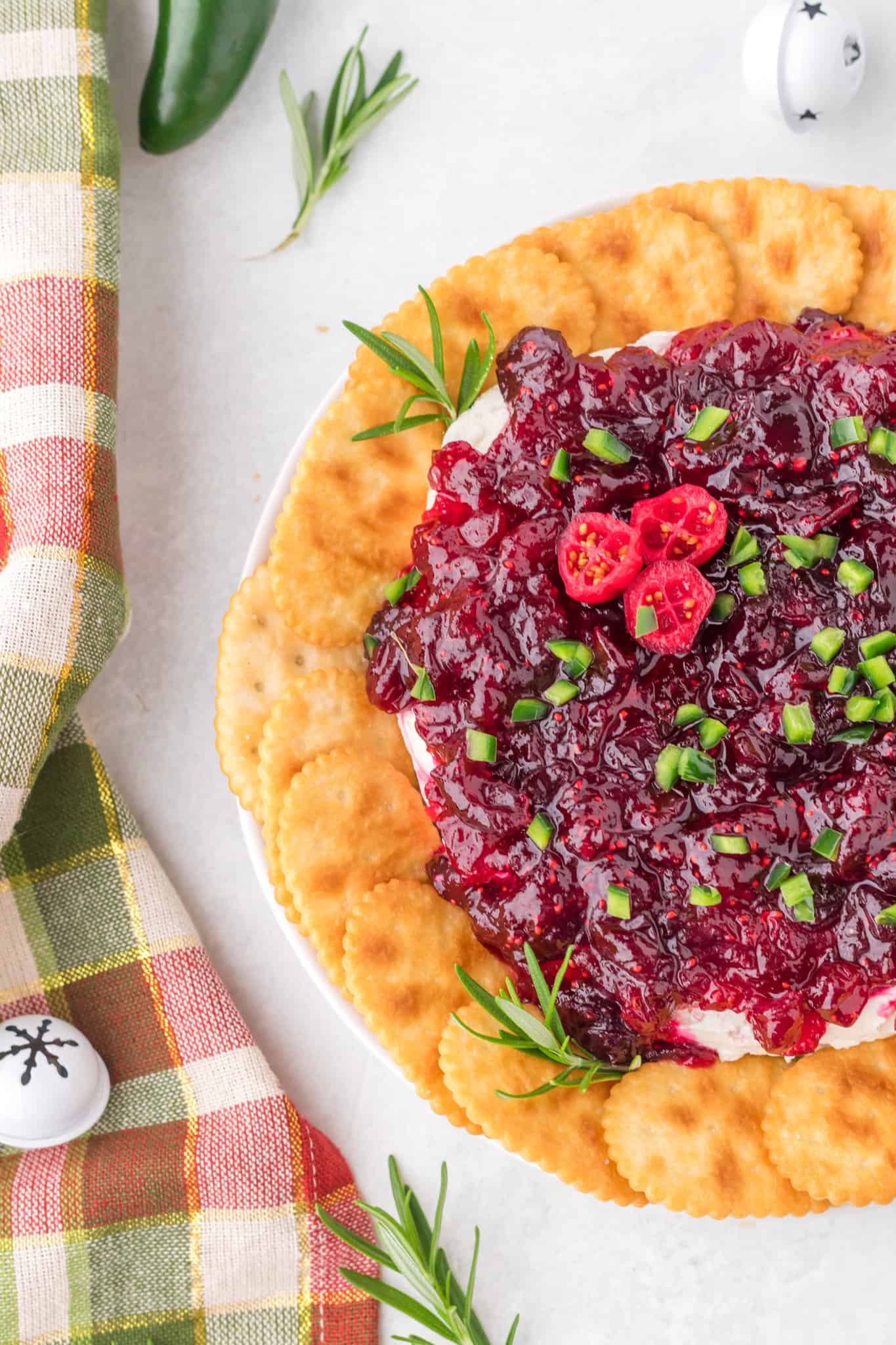 Cranberry Cream Cheese Dip is a delicious party dip recipe with a cream cheese jalapeno base topped with cranberry sauce.