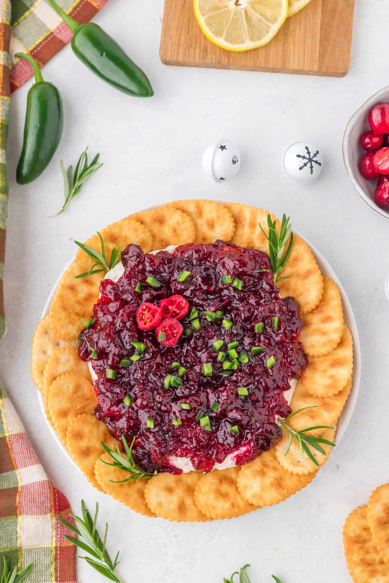 Cranberry Cream Cheese Dip is a delicious party dip recipe with a cream cheese jalapeno base topped with cranberry sauce.