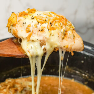 Crock Pot French Onion Chicken is an easy slow cooker chicken breasts recipe made with beef broth, onion soup mix, yellow onions, cream of chicken soup, provolone cheese and French's crispy fried onions.