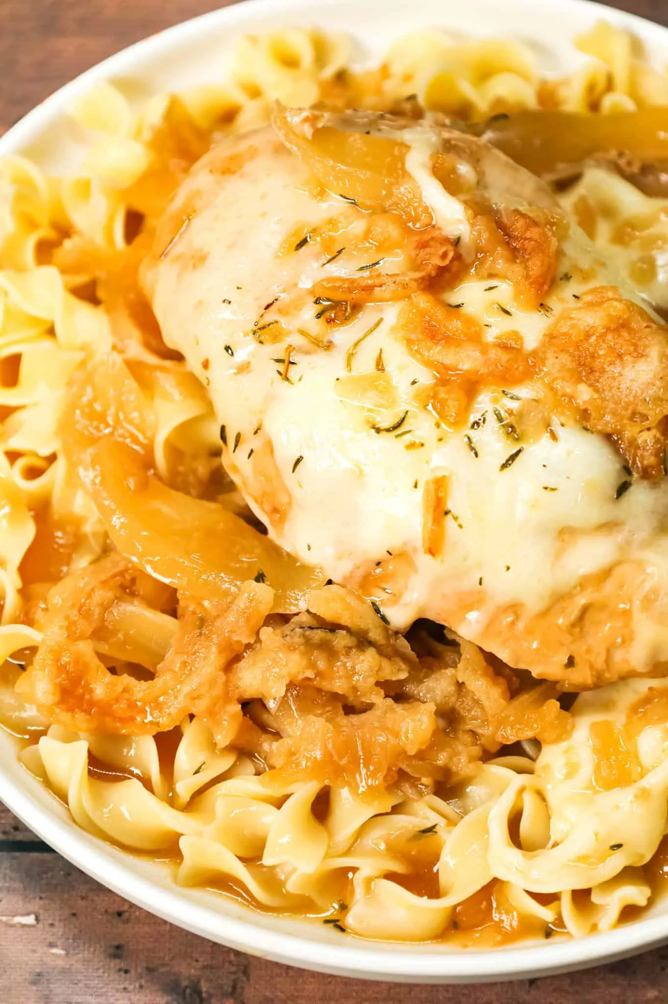 Crock Pot French Onion Chicken is an easy slow cooker chicken breasts recipe made with beef broth, onion soup mix, yellow onions, cream of chicken soup, provolone cheese and French's crispy fried onions.