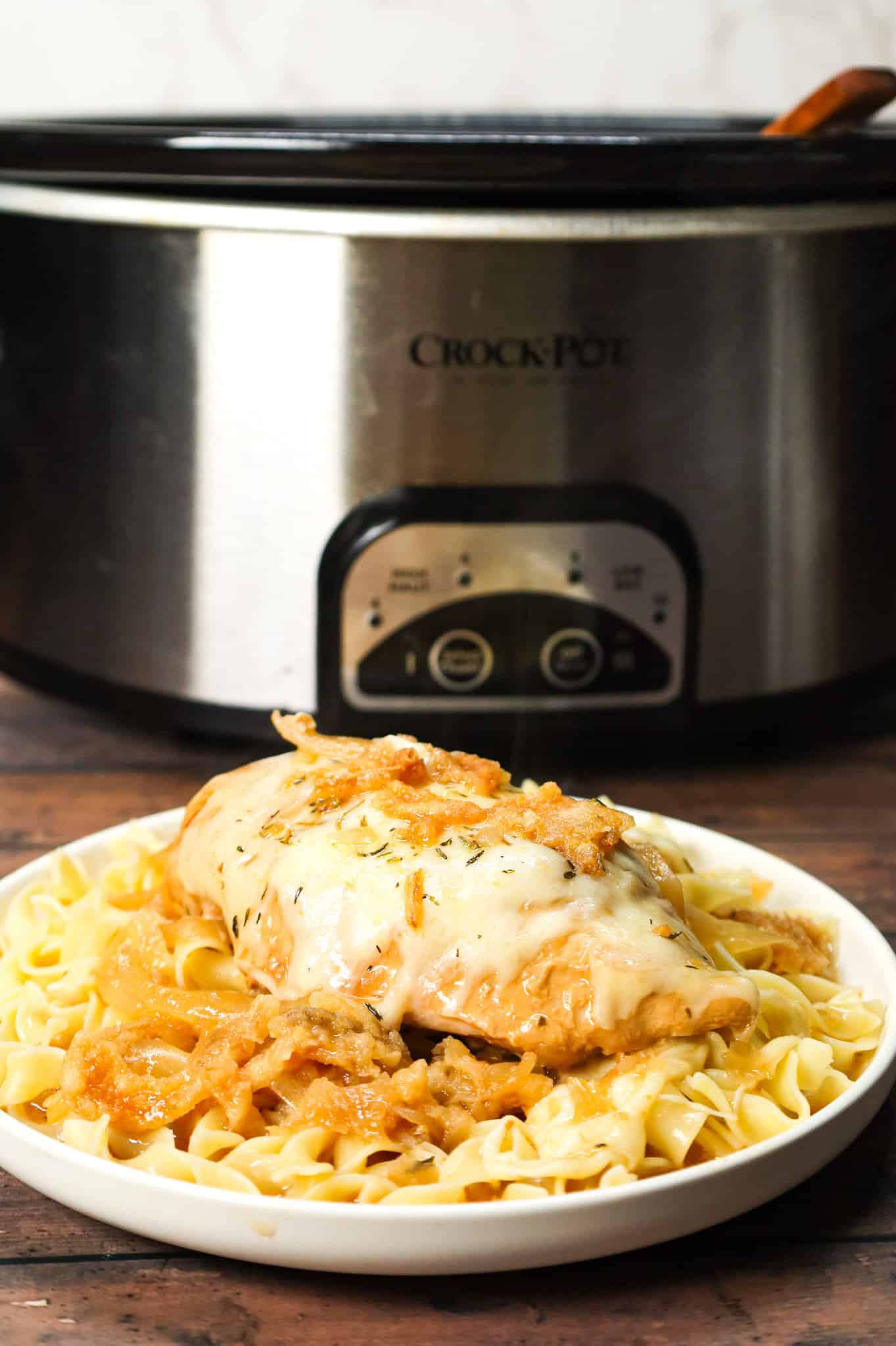 Crock Pot French Onion Chicken is an easy slow cooker chicken breasts recipe made with beef broth, onion soup mix, yellow onions, cream of chicken soup, provolone cheese and French's crispy fried onions.