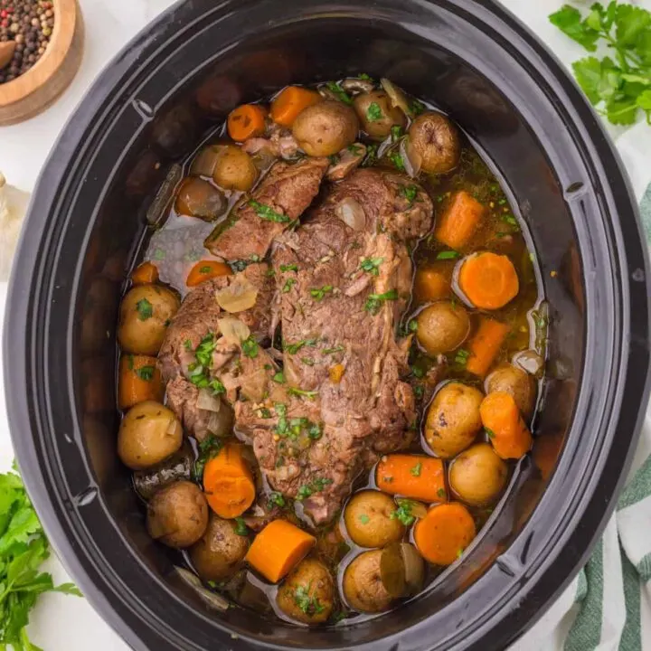 Crock Pot Pot Roast is a complete dinner recipe with a delicious tender beef roast, carrots and baby potatoes all cooked together in the slow cooker.