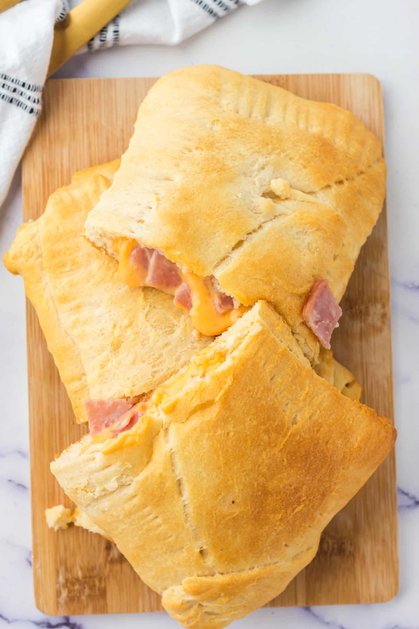 Ham and Cheese Hot Pockets are a kid friendly lunch or dinner recipe using Pillsbury crescent rolls, American cheese slices and chopped ham slices.