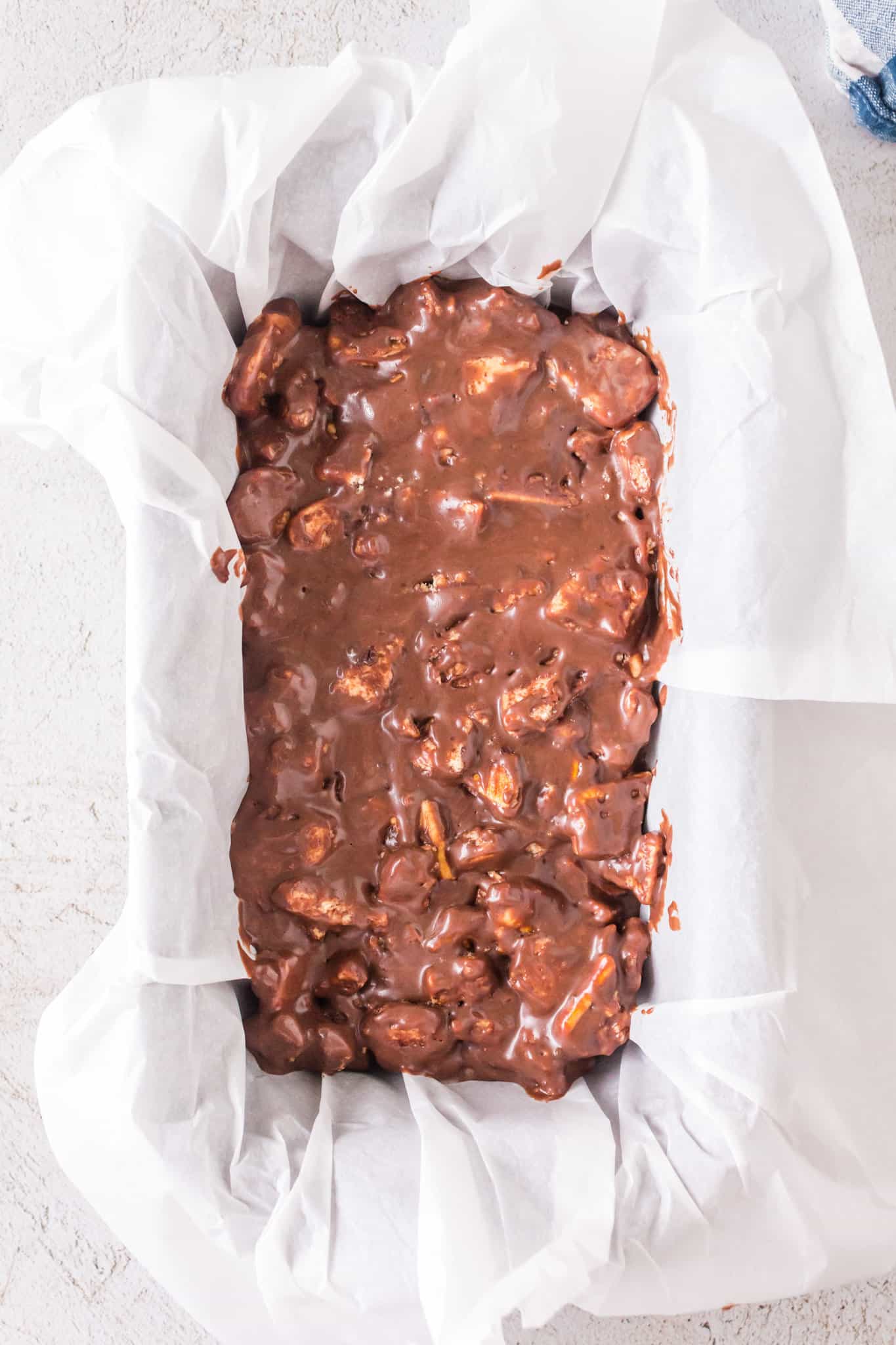 chocolate and butter cookie mixture pressed into parchment lined loaf pan