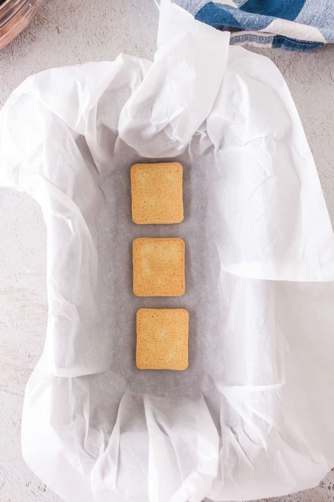 butter cookies in the bottom of a parchment lined loaf pan