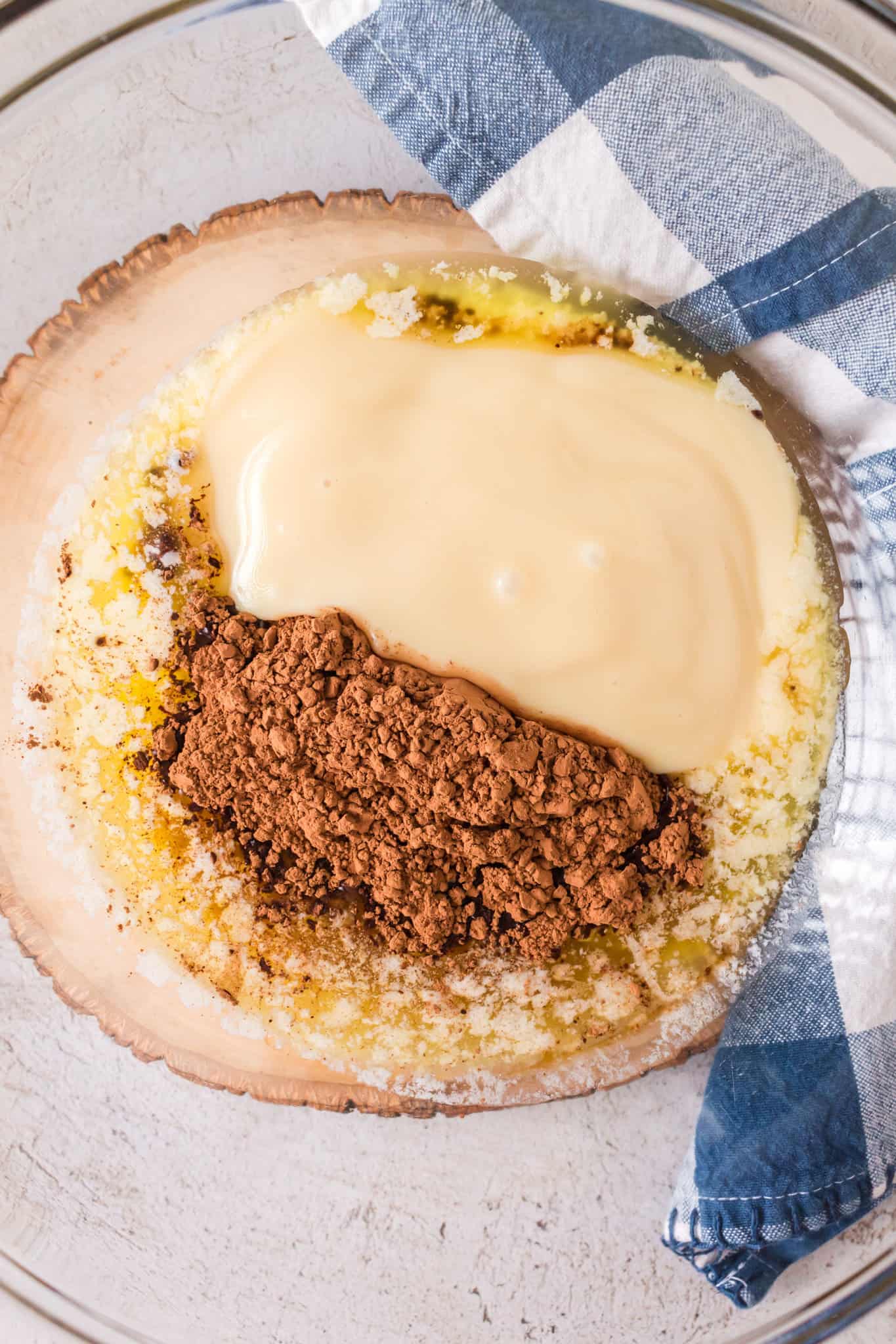 sweetened condensed milk, cocoa powder and melted butter in a mixing bowl