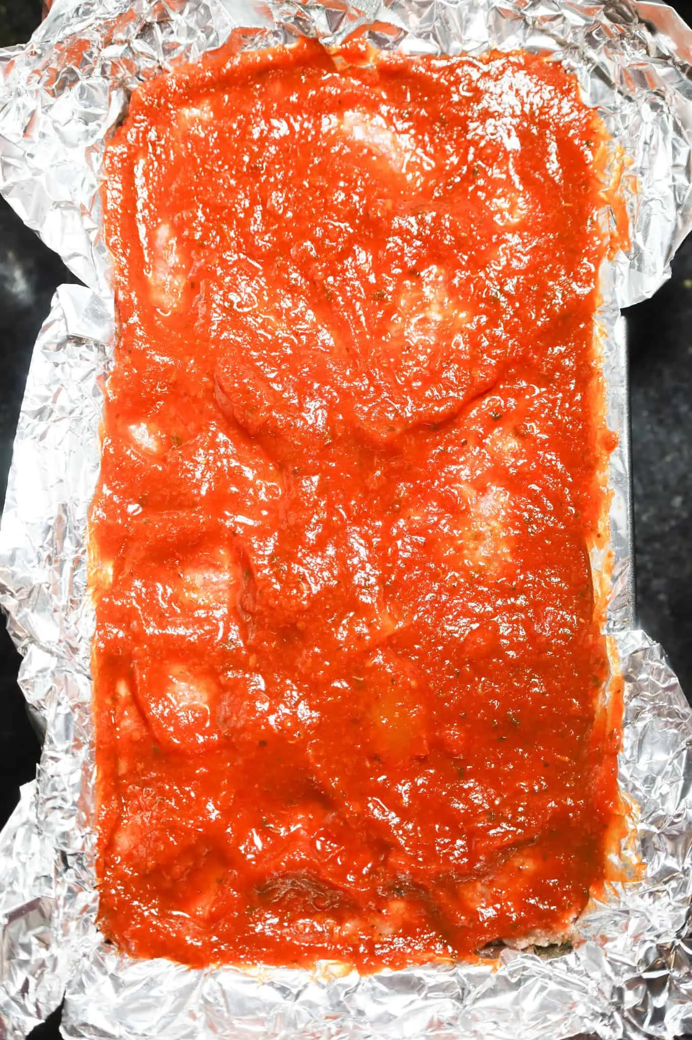 pizza sauce spread on top of meatloaf before baking