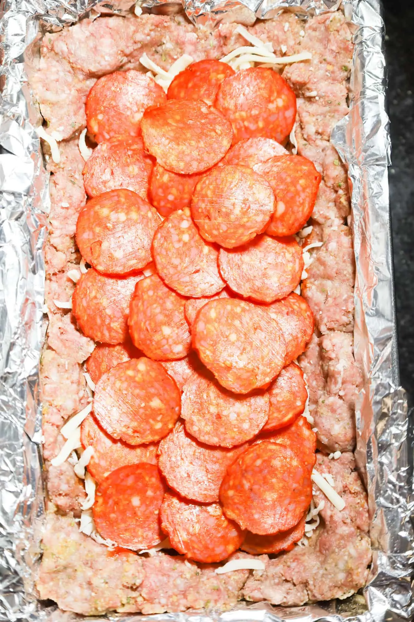 pepperoni slices in the center of a meatloaf