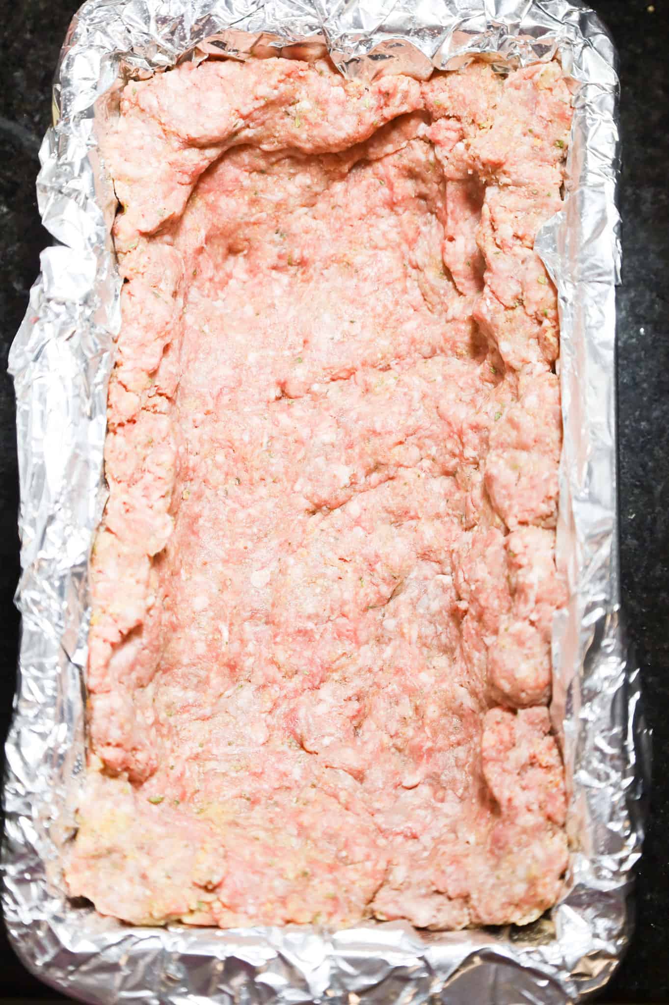 raw ground beef mixture pressed into bottom and up the sides of a foil lined loaf pan