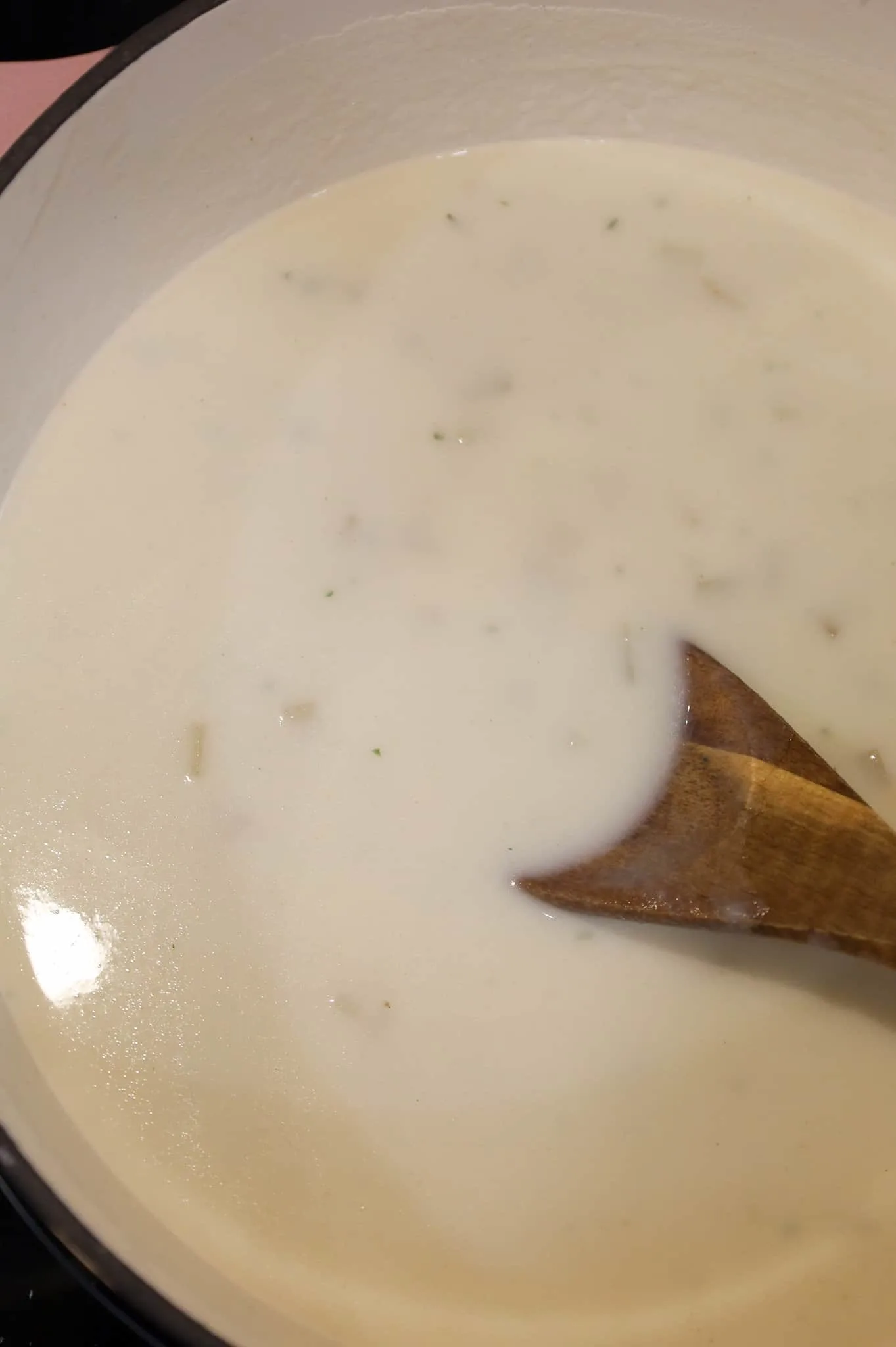 stirring potato soup in a pot