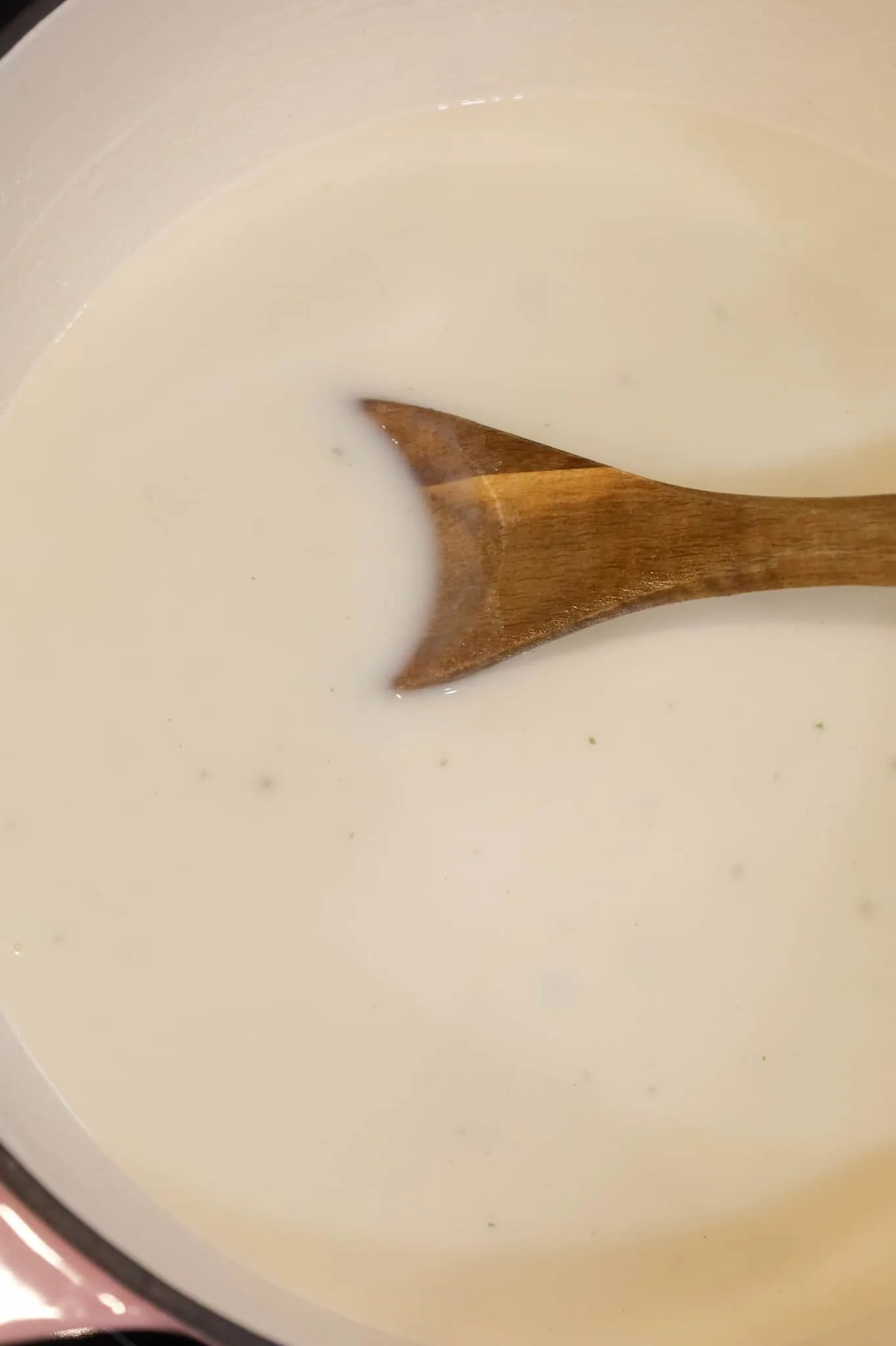 stirring milk into chicken broth and mashed potato mixture