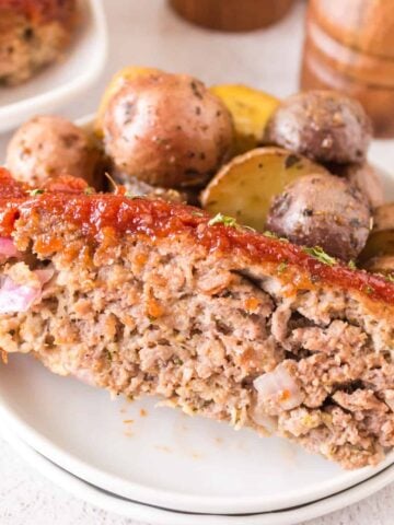 Air Fryer Meatloaf is a simple ground beef meatloaf recipe made with Italian seasoned bread crumbs and topped with a brown sugar ketchup glaze.