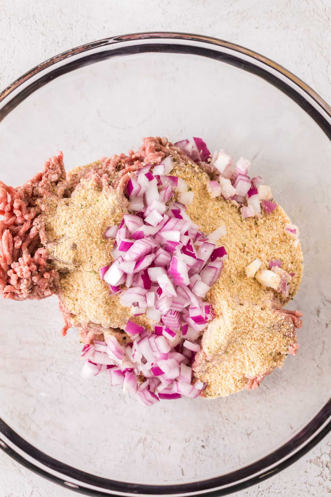 diced onions, bread crumbs and ground beef mixture in a mixing bowl