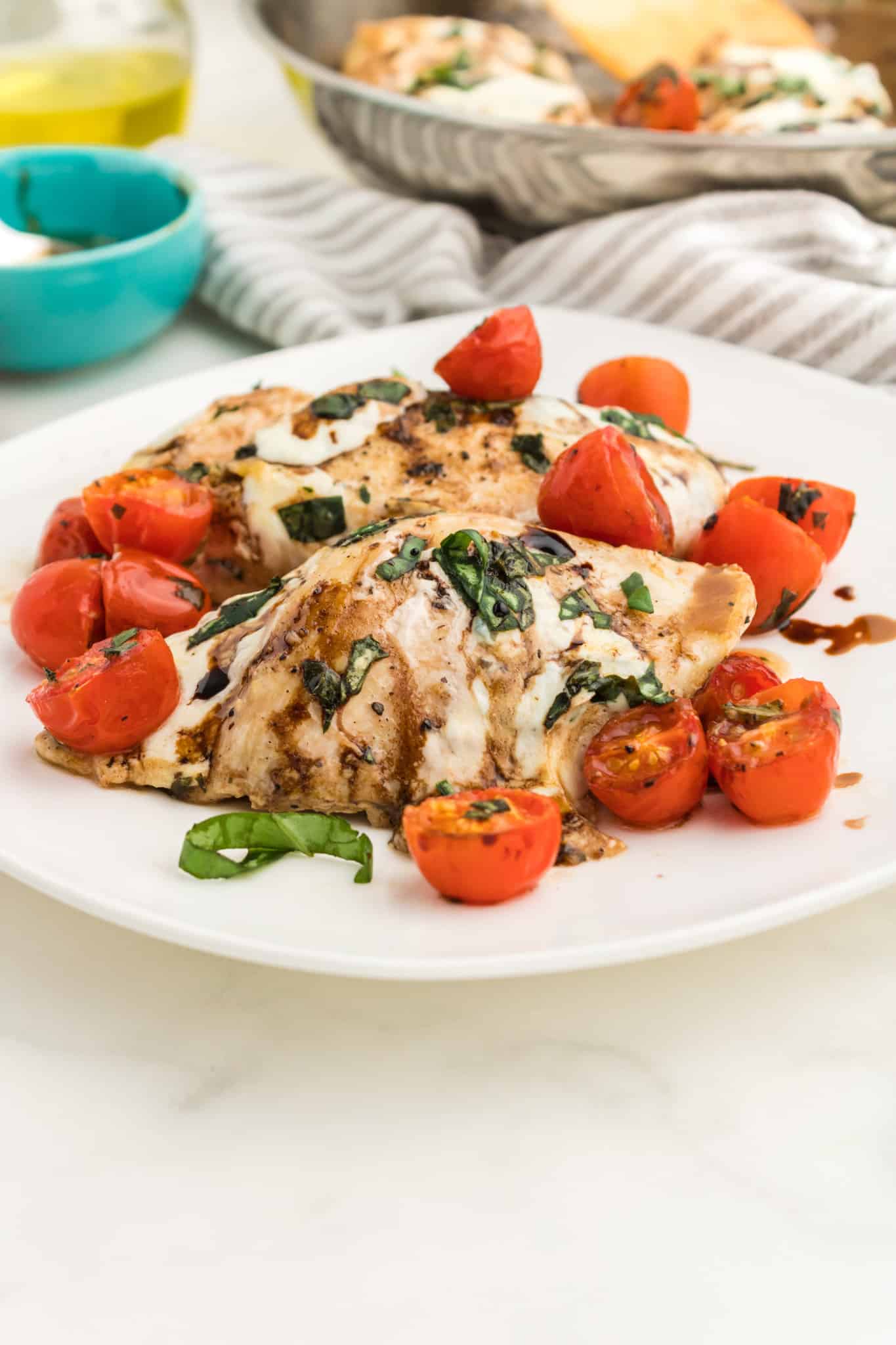 Caprese Chicken is a delicious chicken dish loaded with cherry tomatoes, fresh mozzarella, basil and balsamic vinaigrette.