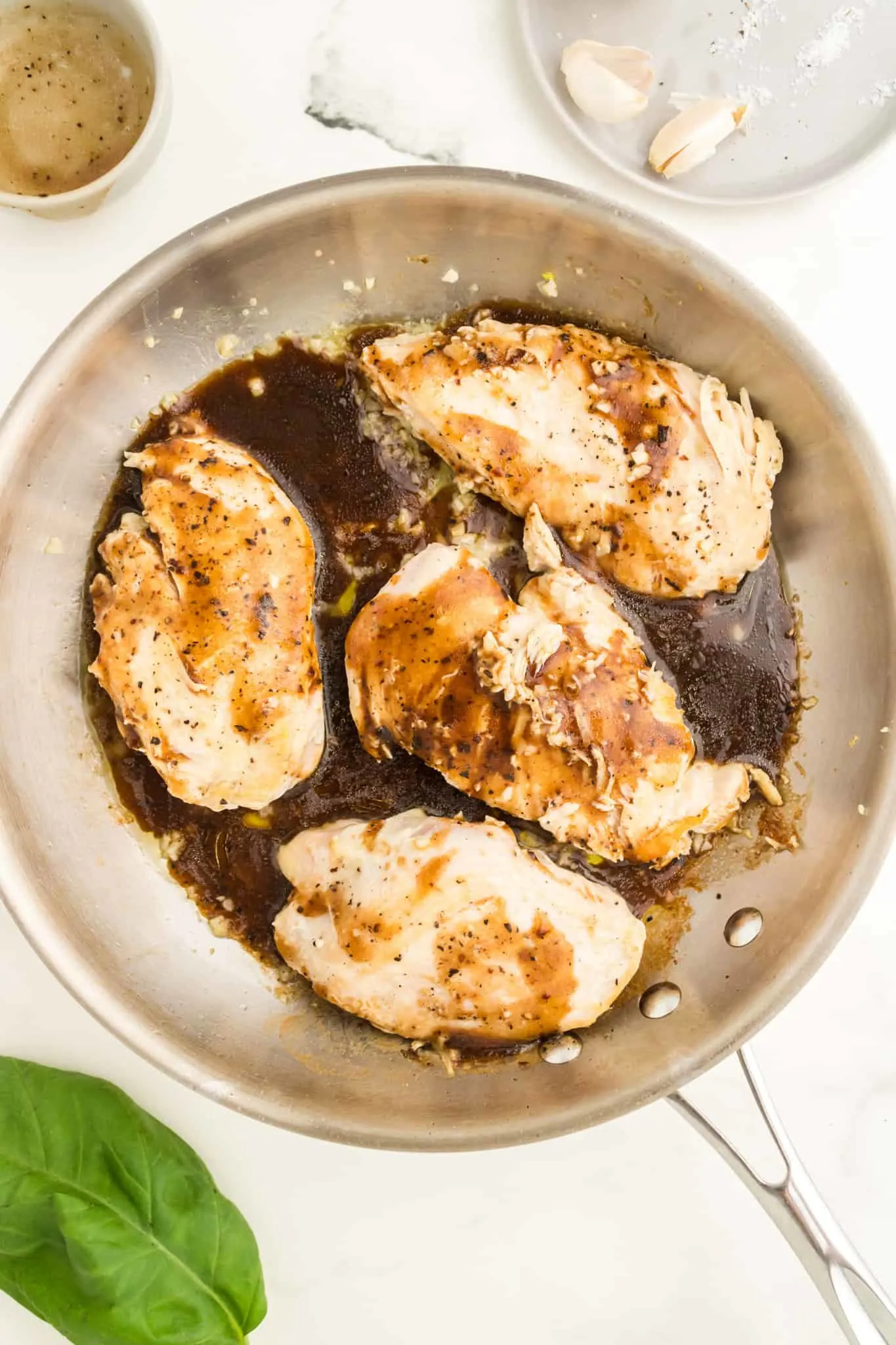 balsamic vinaigrette on top of chicken breasts in a skillet